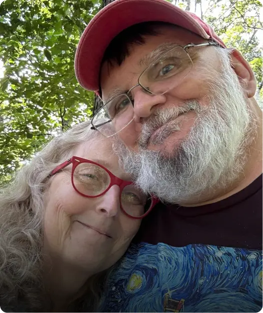 A man and woman are smiling for the camera.