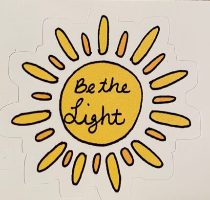 A sticker of the sun with the words " be the light ".