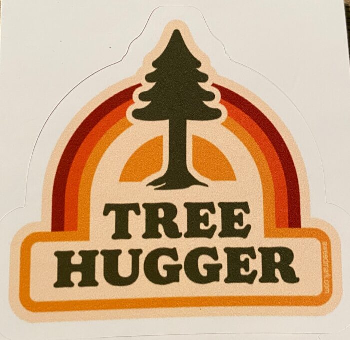 A sticker that says tree hugger with trees and rainbow.