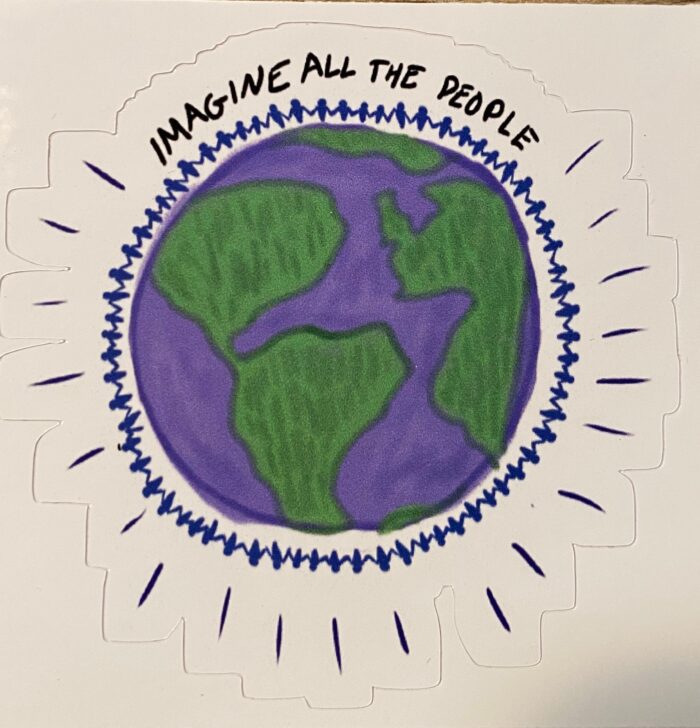 A sticker of the earth with words written on it.