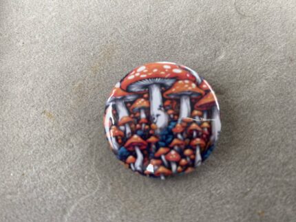 A button with mushrooms on it sitting on top of a table.