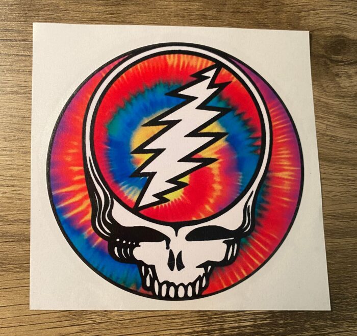 A sticker of the grateful dead with a tie dye design.