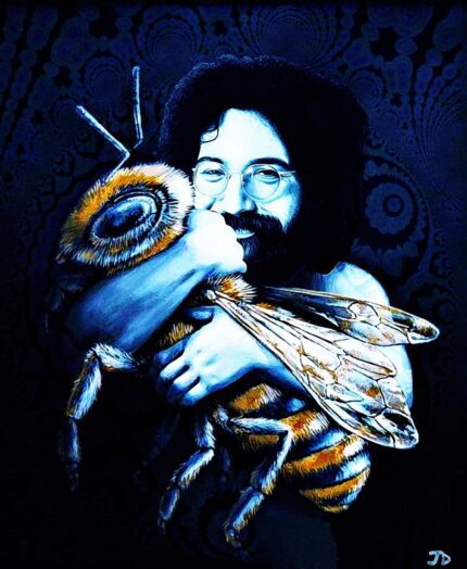 Man with long hair holding a bee.