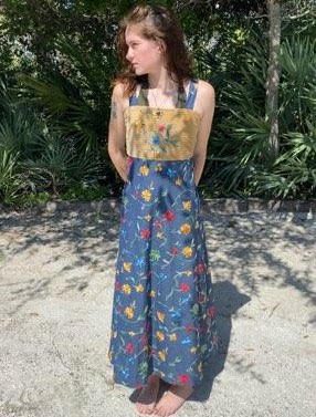 Woman wearing a blue floral maxi dress.