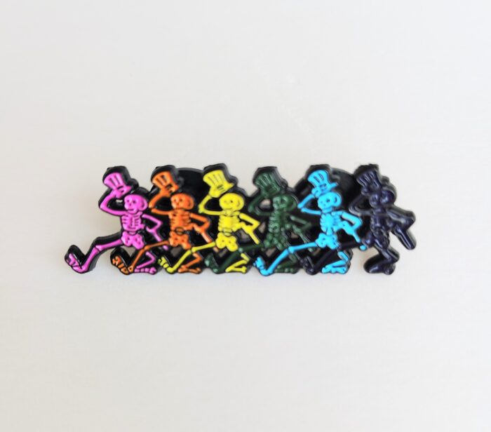 Rainbow skeleton dancing pin badge.