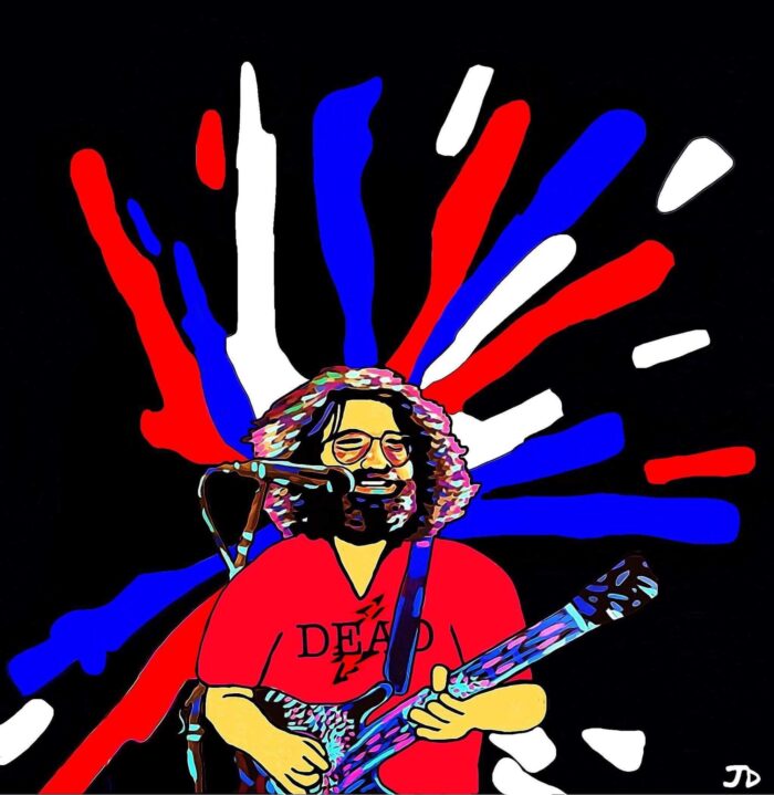 Jerry Garcia playing guitar with "Dead" shirt.