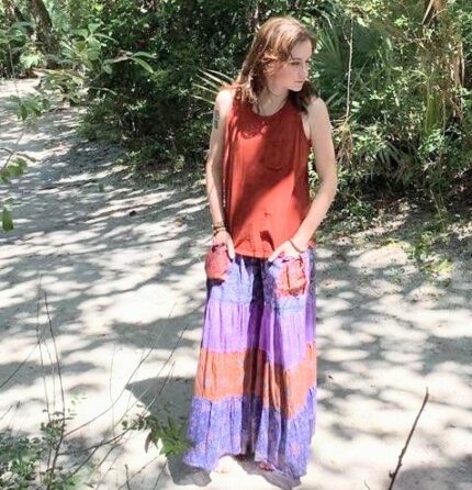 Woman in red tank top and long skirt.