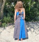 Woman in blue and brown dress with back facing camera.