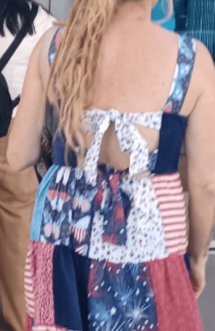 Woman with blond dreadlocks wearing a patriotic dress.