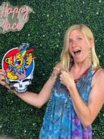 Woman pointing to a Grateful Dead patch.