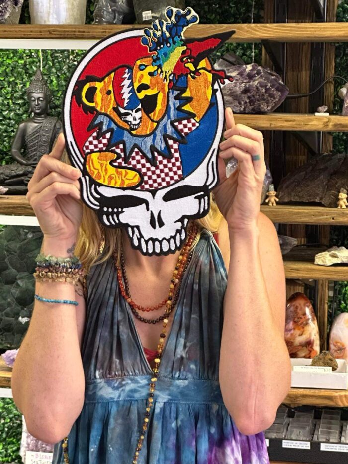 Woman holding Grateful Dead skull patch.