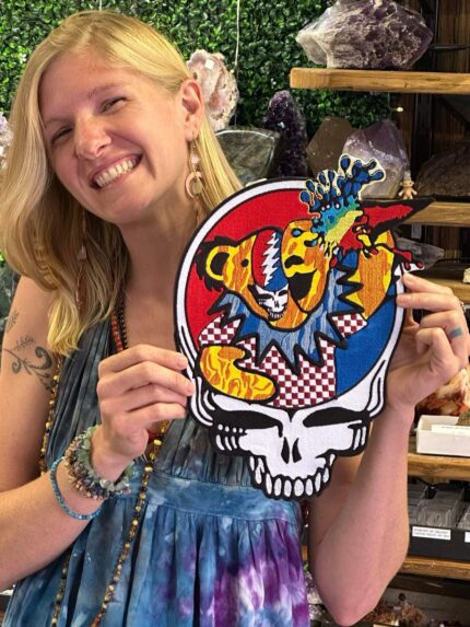 Woman holding a Grateful Dead patch.