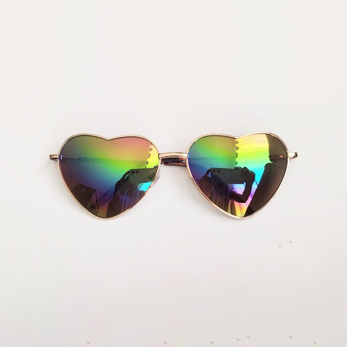 Heart-shaped sunglasses with iridescent lenses.