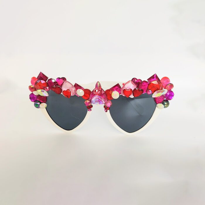 White heart-shaped sunglasses with pink gems.