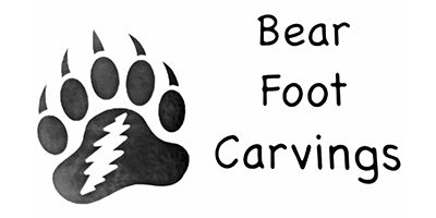 Black and white bear paw print carving.