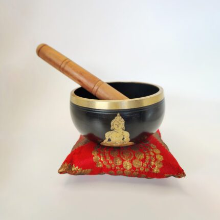 Black singing bowl with Buddha design.