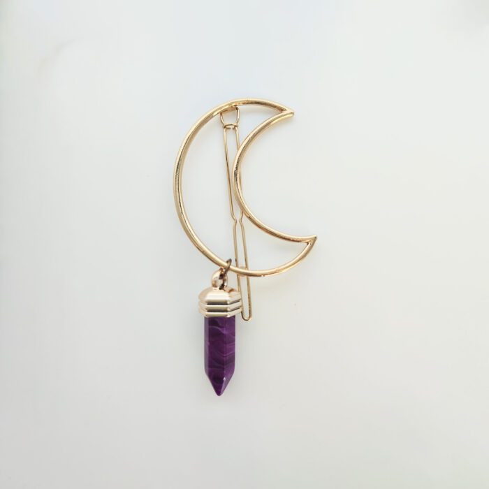 Gold crescent moon hair clip with purple crystal.