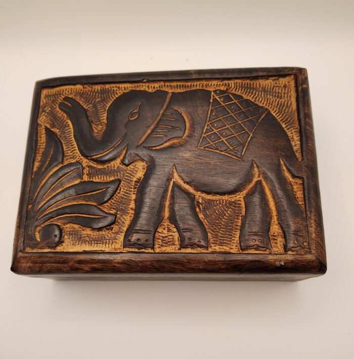 Wooden box with carved elephant design.