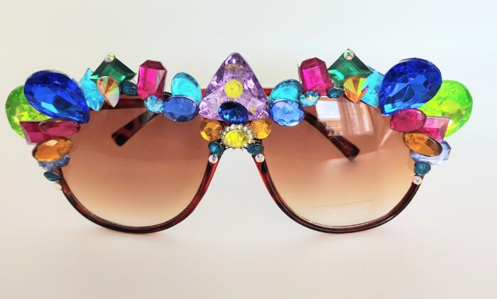 Red sunglasses with jeweled frames.