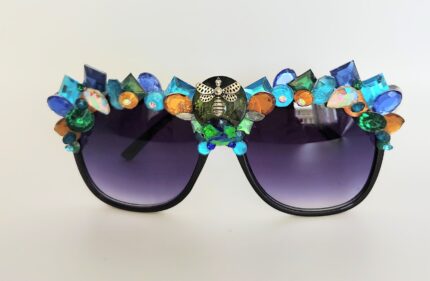 Black sunglasses with colorful gems and a bee.