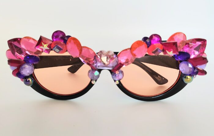 Black sunglasses with pink and purple gems.