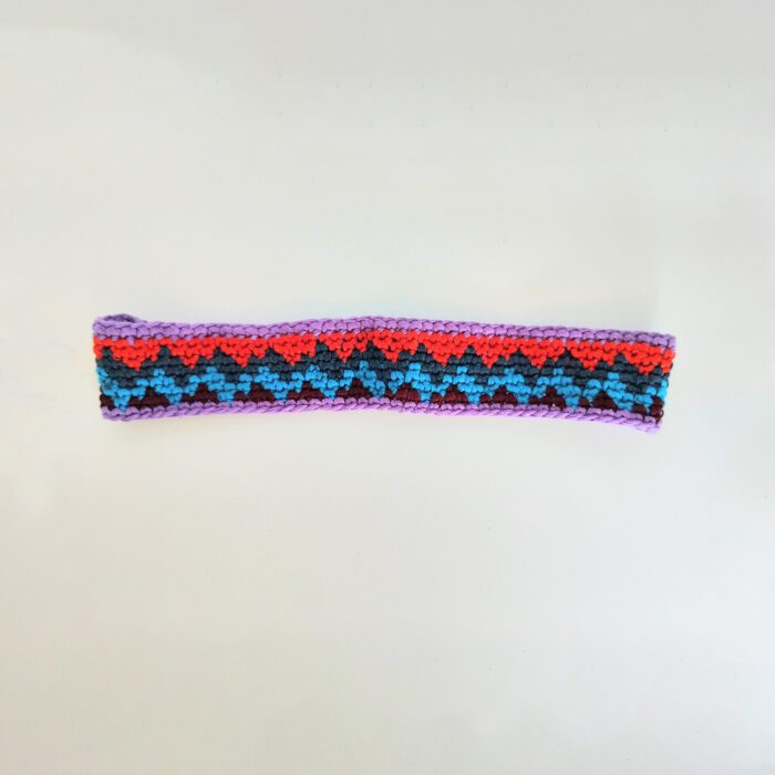 Crocheted headband with colorful chevron design.