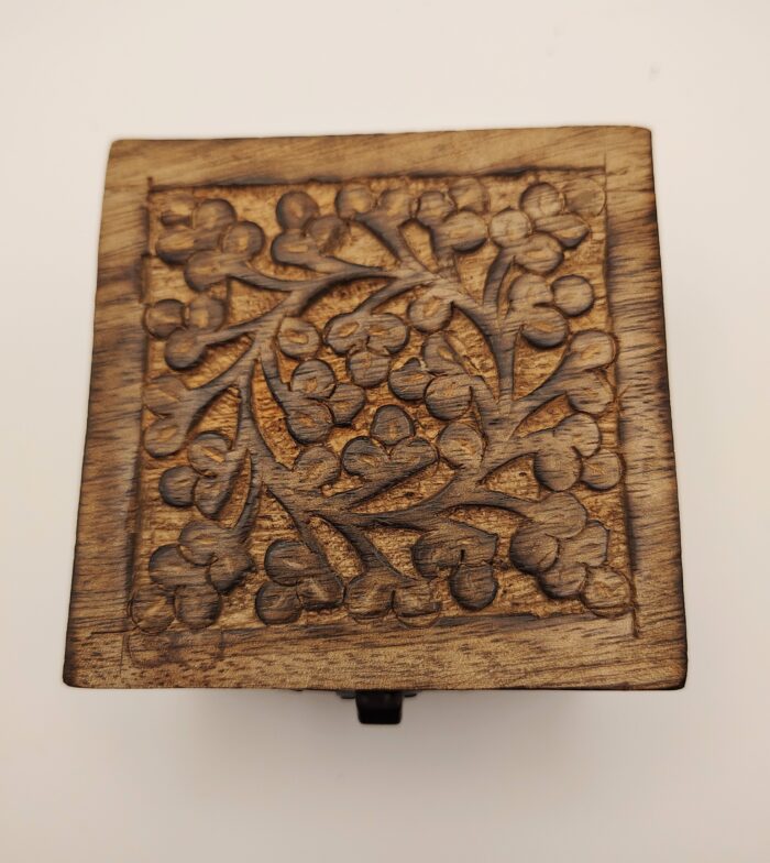 Wooden box with floral carving.