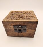 Carved wooden box with a latch.