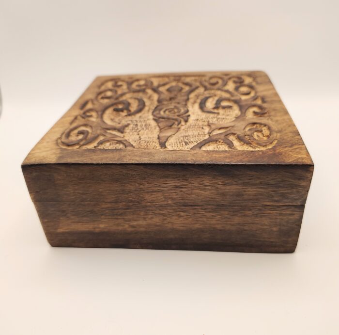 Carved wooden box with intricate design.