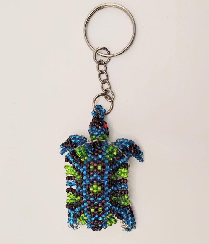 Beaded sea turtle keychain on white background.