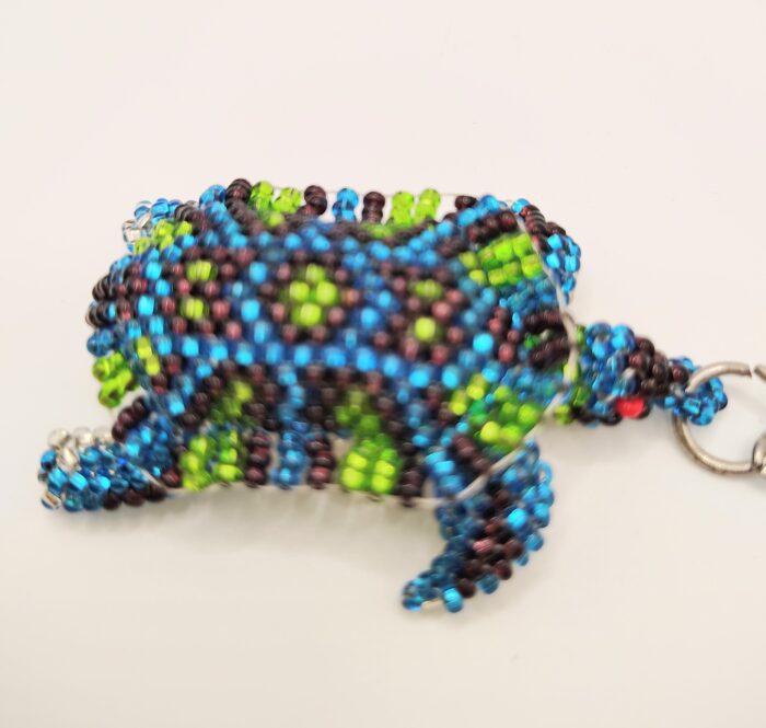 Beaded turtle charm with silver clasp.