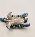 Beaded turtle keychain with blue accents.