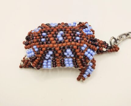 Beaded turtle keychain with a chain.