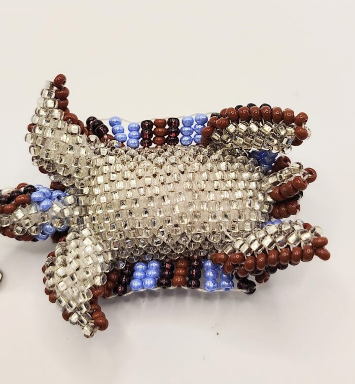 Beaded turtle ornament with blue, brown, and silver beads.