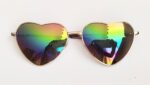 Heart-shaped iridescent sunglasses with reflection.