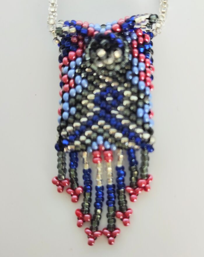 Beaded pendant necklace with tassel.