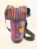 Colorful patterned bottle carrier with strap.