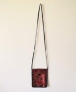 Red floral embroidered crossbody bag.