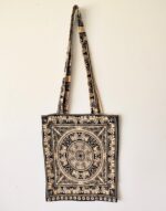 Black and tan tote bag with elephant design.