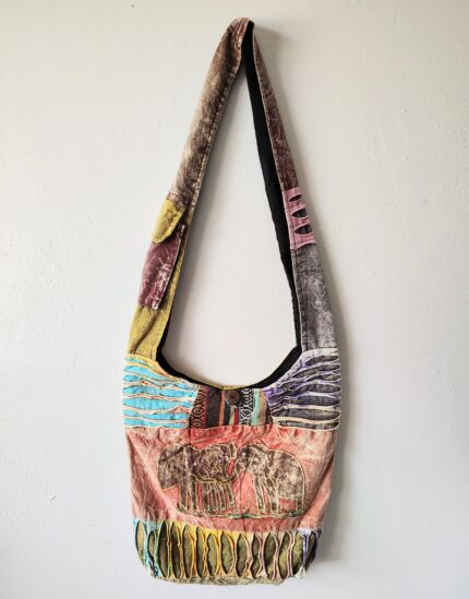 Patchwork shoulder bag with elephant design.