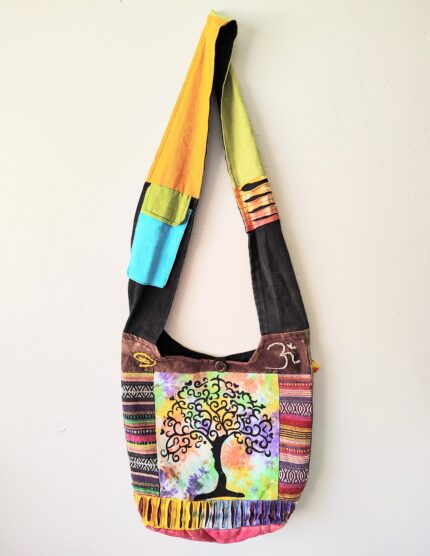 Colorful patchwork tote bag with tree design.