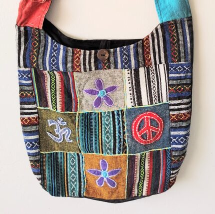 Patchwork shoulder bag with peace sign and flowers.