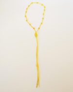 Yellow beaded necklace with tassel.