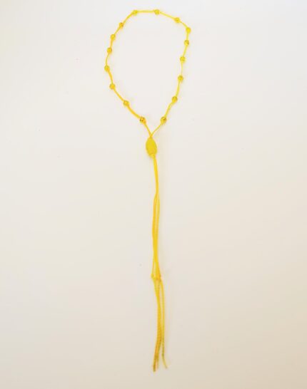 Yellow beaded necklace with tassel.