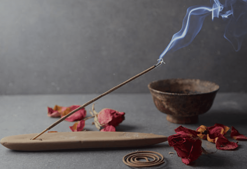 Incense burning with rose petals.