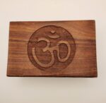 Wooden box with carved Om symbol.