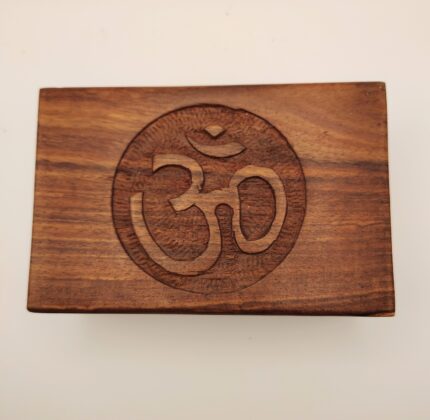 Wooden box with carved Om symbol.