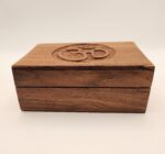 Wooden box with Om symbol carved on top.