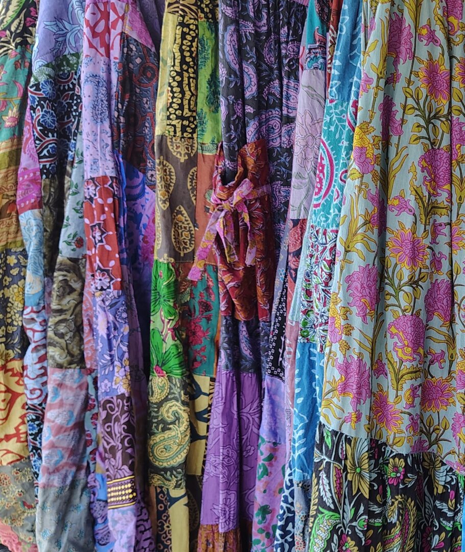 Colorful patterned fabric skirts hanging.