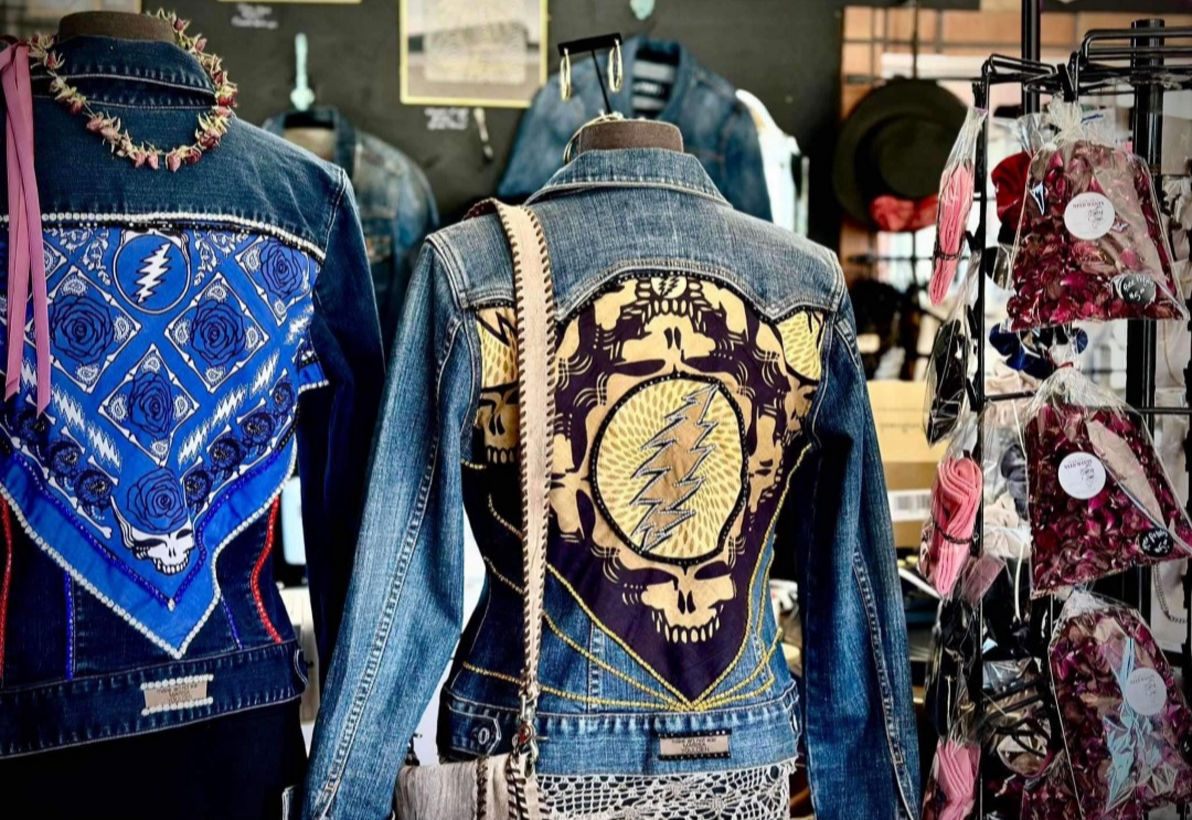 Two denim jackets with embroidered designs.